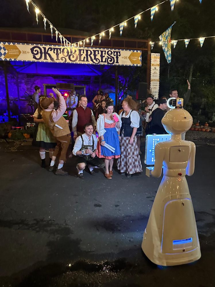 Robot photo booth photographing guests in lederhosen and dirndls at the Darien Chamber Oktoberfest