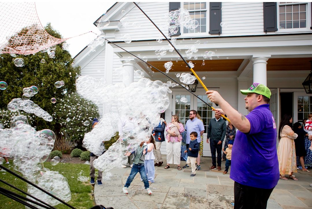 Scotty sending a wall of bubbles across a backyard party