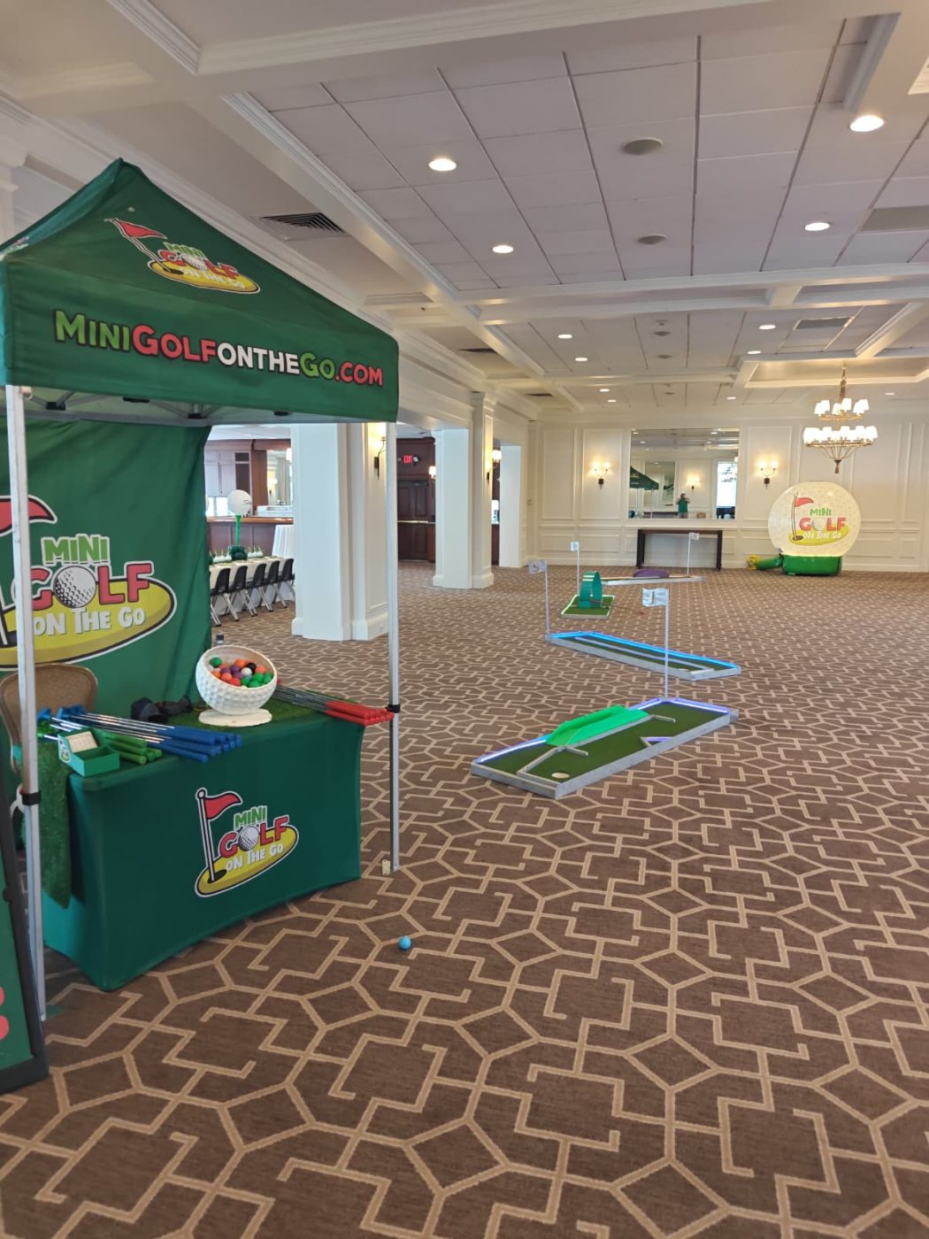 Mini golf course laid out across a country club ballroom