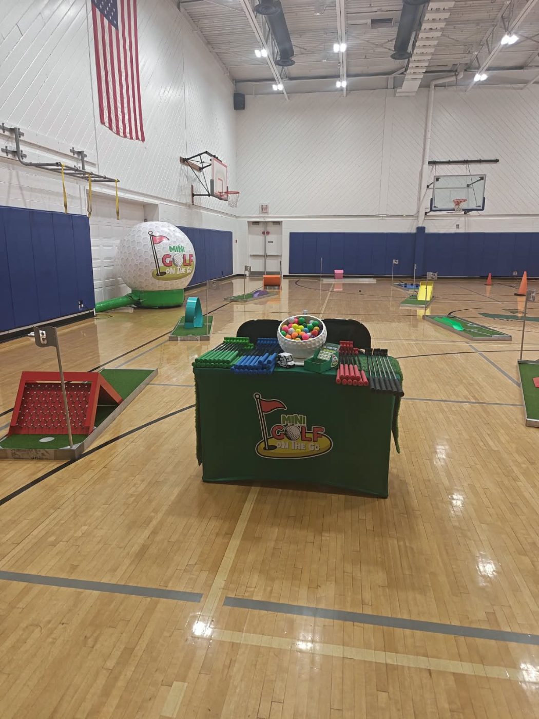 A full mini golf course set up across a school gym floor