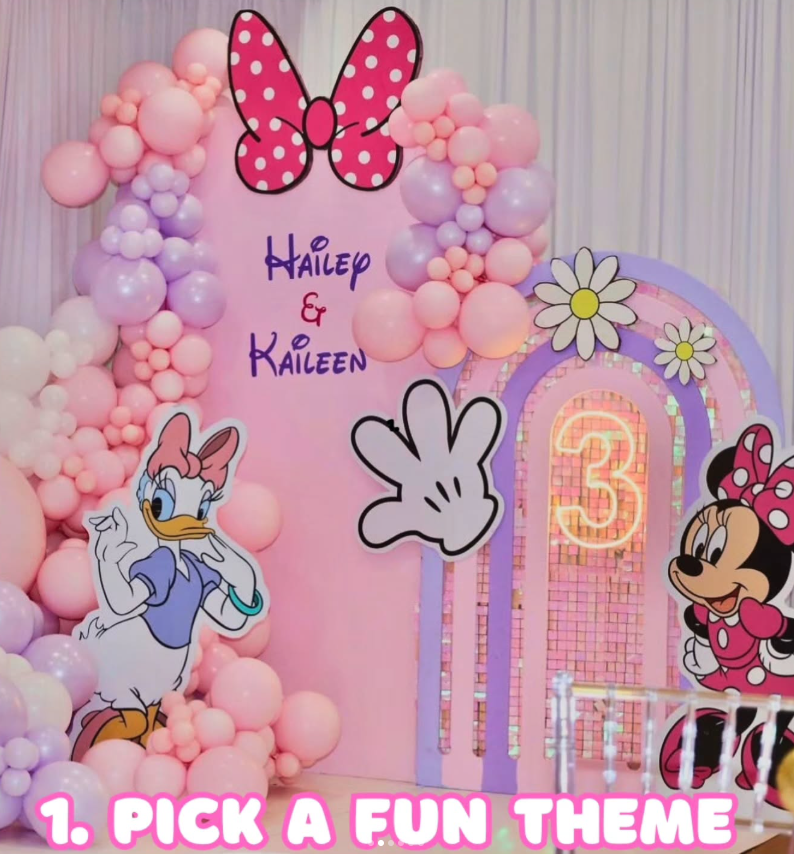 A pastel Minnie Mouse balloon arch and backdrop built for a third birthday