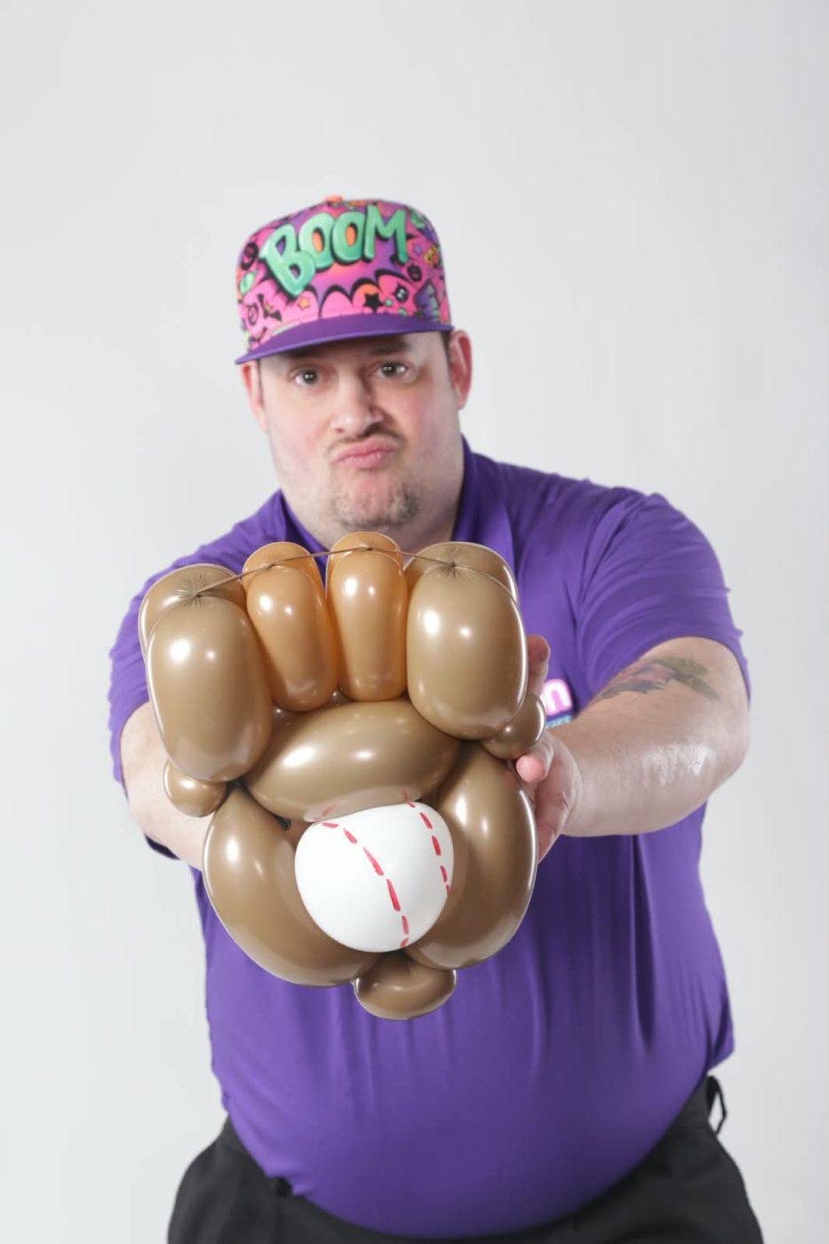A balloon baseball glove and ball twisted for a sports-themed party