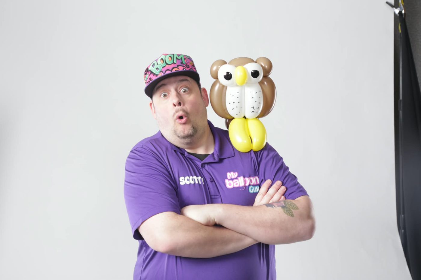 Scotty with a balloon owl perched on his shoulder